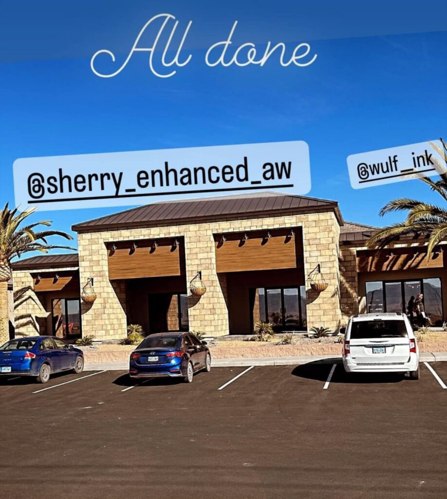 A modern, tan-brick building with wood accents is seen under a clear blue sky. Two palm trees and several parked cars are in front. Text reads “All done” with Instagram handles @sherry_enhanced_aw and @wulf_ink. window tinting